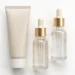 Skincare cream tube and serum bottles on a clean white background