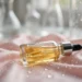 Photograph of a serum dropper bottle with golden liquid on pink silk