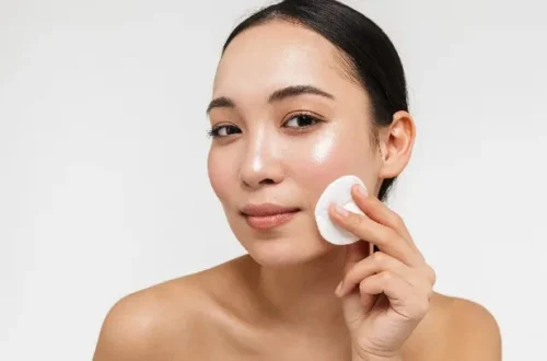Woman applying facial toner to her face