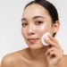 Woman applying facial toner to her face