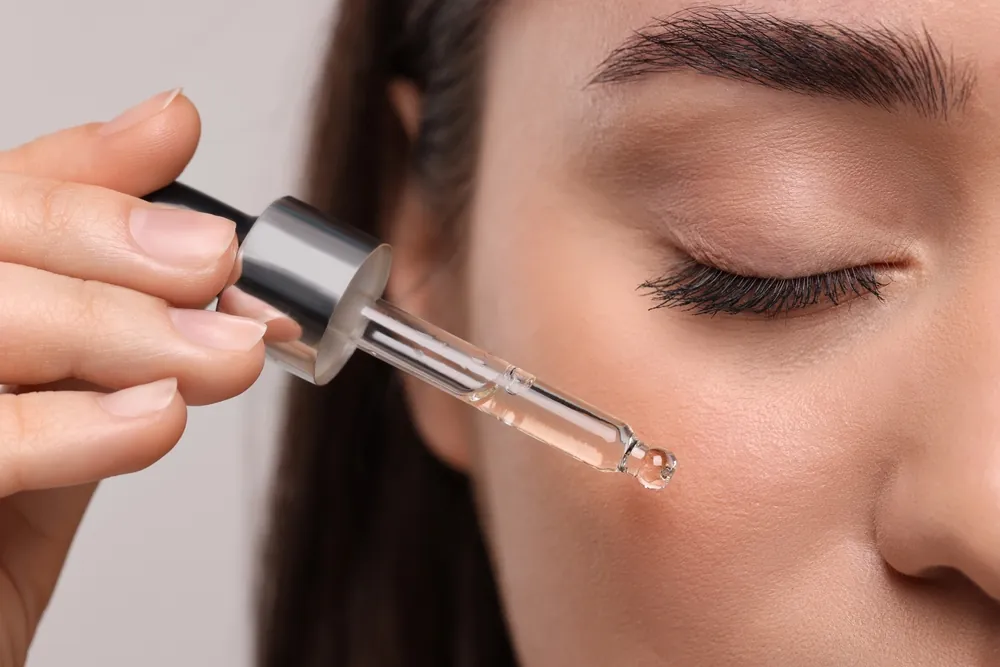 Close-up of serum being applied to skin with a dropper