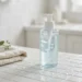 Gel cleanser bottle with water droplets on a bathroom counter