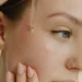 Person applying facial serum as part of a skincare routine