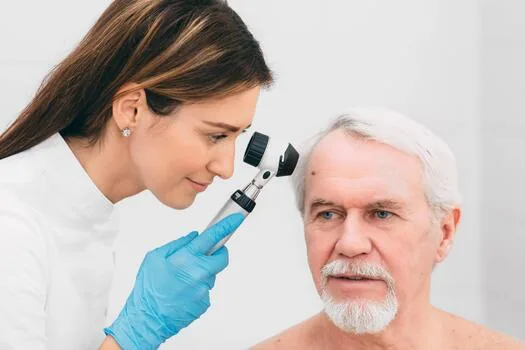 A dermatologist examining a patient's skin in a clinic
