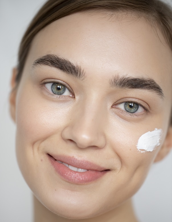 Applying moisturizer to keep skin hydrated and clear
